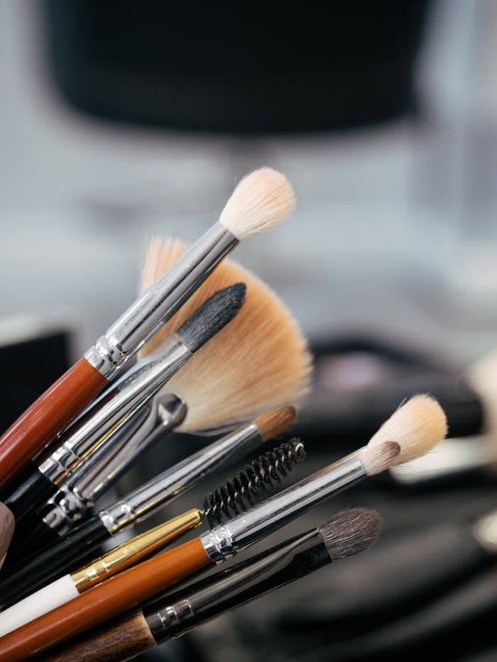 Detailed view of various makeup brushes in a vertical arrangement, perfect for beauty and cosmetics themes.